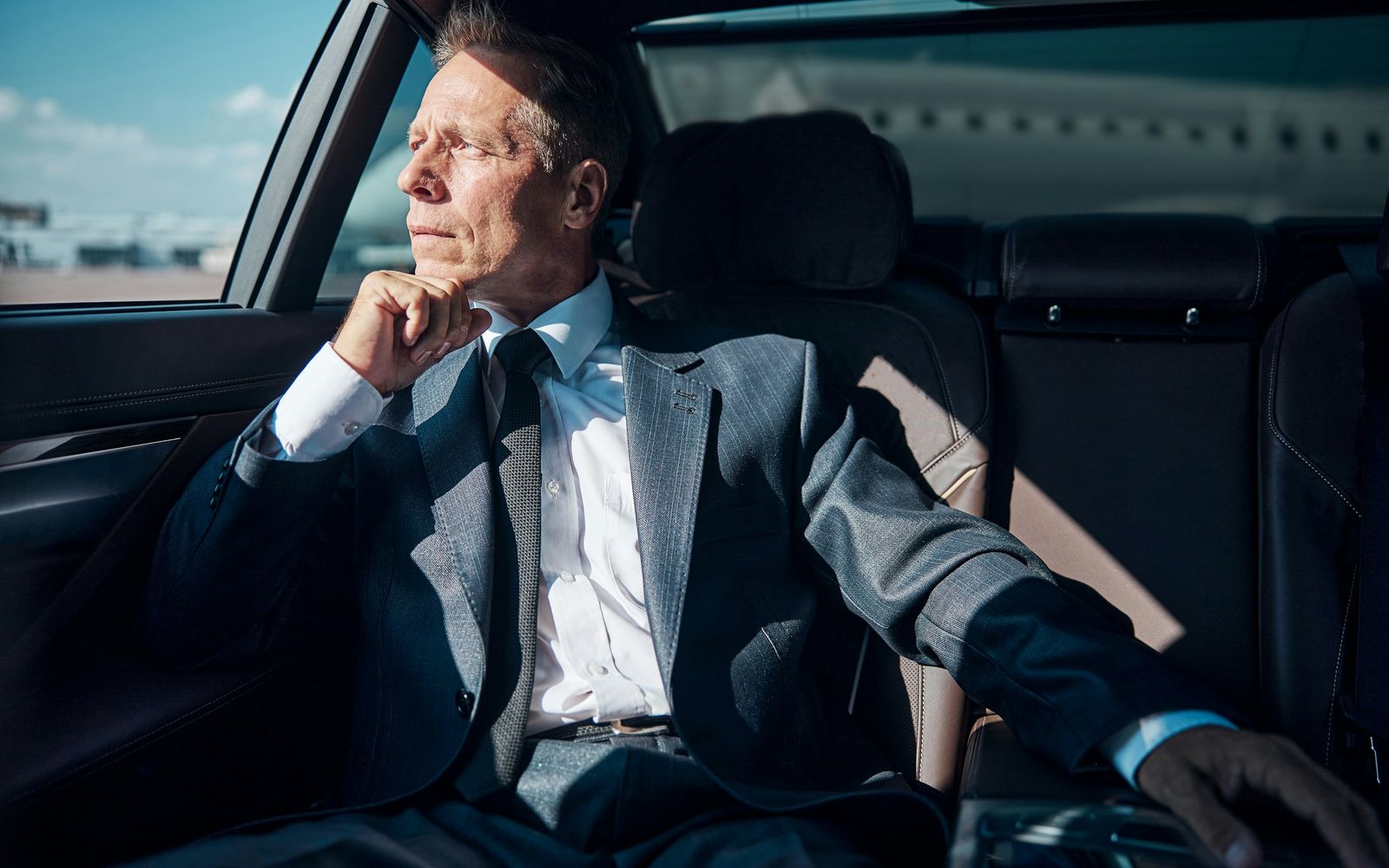 Executive stepping out of a black Mercedes