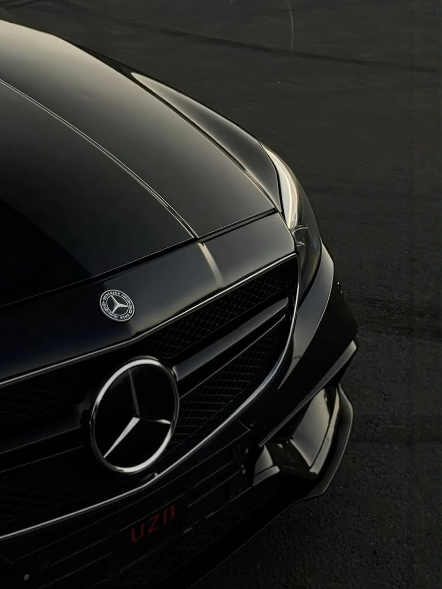 Black Mercedes waiting for a passenger at an airport terminal